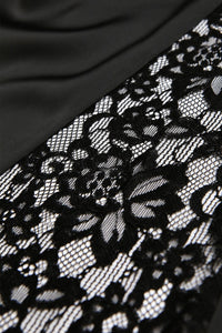 Black lace trim with an intricate floral pattern featuring open mesh details, displayed against a dark fabric background. The delicate lace showcases fine embroidered designs with a romantic, elegant aesthetic suitable for lingerie or apparel embellishment.