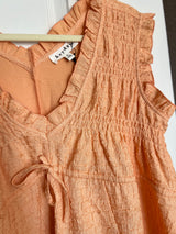 Light brown textured dress with a brand tag on a white background