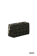 A black quilted cosmetic bag with a textured tweed pattern and gold-tone zip closure, displayed against a white background.