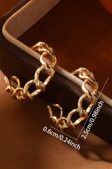 Gold chain bracelet on a brown background with measurements indicated