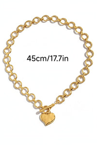 A gold-toned chain necklace featuring interlocking circular links and a polished heart pendant charm. The necklace measures 45cm (17.7 inches) in length.