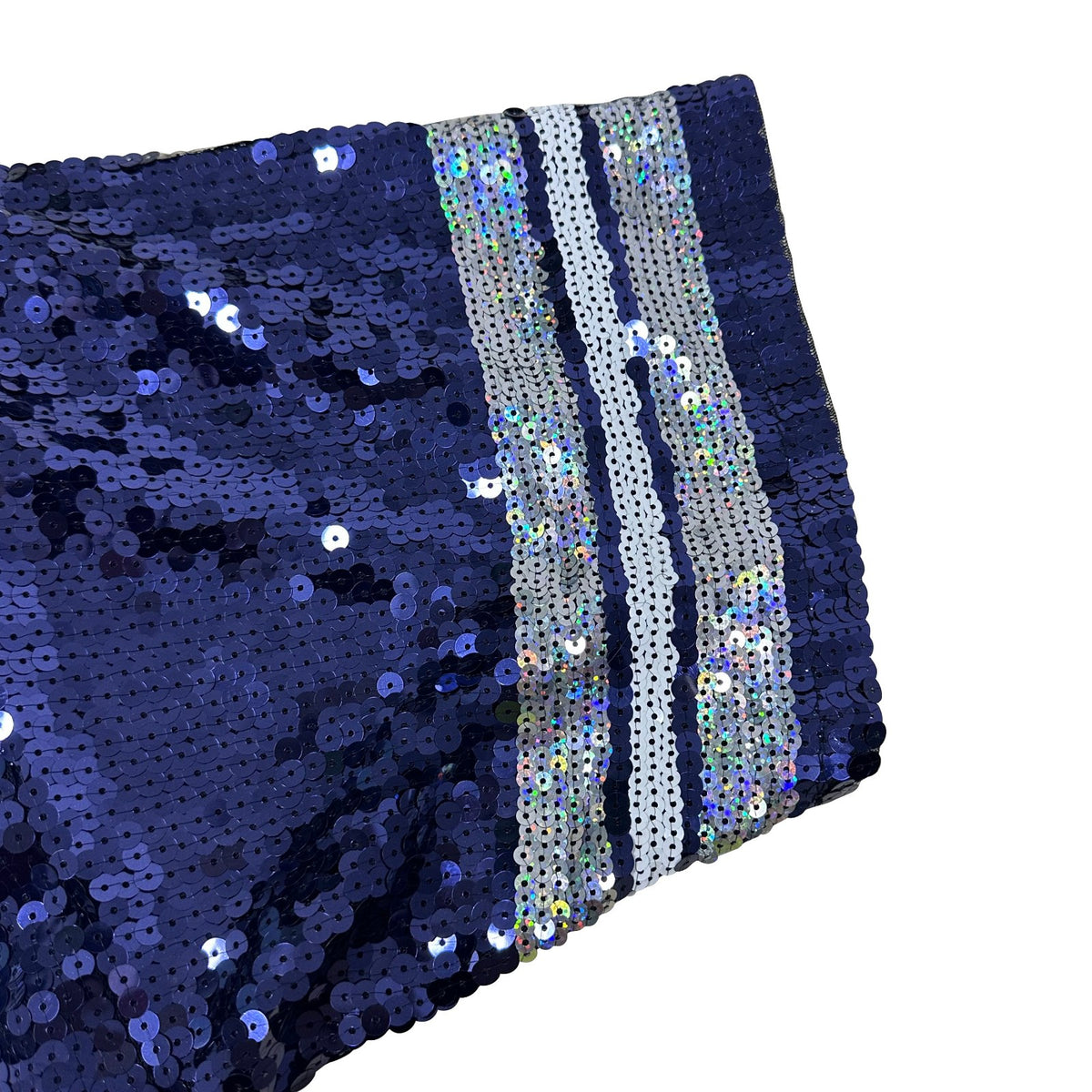 A navy blue sequined garment with a decorative striped trim featuring white, silver, and iridescent sequins along the edge, displaying the shimmering reflective quality of the embellished fabric.