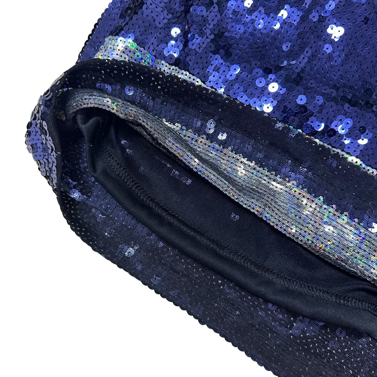 Close-up of a navy blue sequined pouch or clutch with iridescent blue and silver sequins covering the exterior, featuring a black fabric interior and a metallic trim detail along the opening edge.