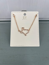 Rose gold-toned necklace with a delicate wavy heart pendant outlined in small crystals, displayed on a cream-colored rectangular jewelry card with decorative perforated border.
