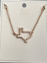 Rose gold-toned necklace from Icon Collector featuring a geometric pendant with crystal embellishments connected to a delicate chain. The pendant displays an angular, abstract design with sparkly rhinestone detailing throughout.
