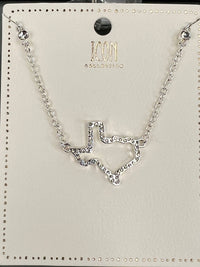 Silver-tone chain necklace from ICON Collection featuring a rhinestone-embellished chevron pendant in the center, displayed on a branded product card with a black circular ornament at the top.