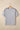 A light gray short-sleeve t-shirt on a wooden hanger featuring black and white striped trim along the shoulders. The shirt has a simple crew neckline and relaxed fit displayed against a neutral beige background.