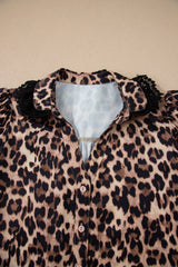 Leopard print blouse with puffed black ruffled sleeves and a light blue collar, featuring white button closures down the front.