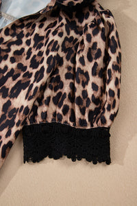 A leopard print long-sleeve top in tan and black with a fitted black lace trim at the hem, displayed flat on a neutral background.