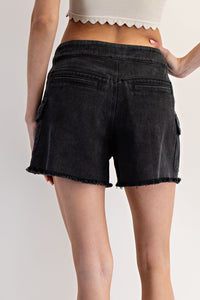 Black denim shorts with a high waist and frayed hem, shown from the back on a model wearing a cream crop top.