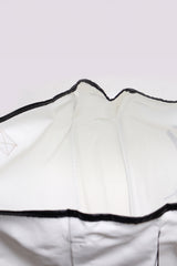 A white sleeveless athletic or casual tank top with black binding trim along the neckline and armholes, displayed flat against a neutral background.