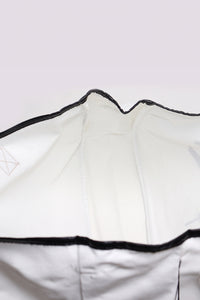 A white sleeveless athletic or casual tank top with black binding trim along the neckline and armholes, displayed flat against a neutral background.