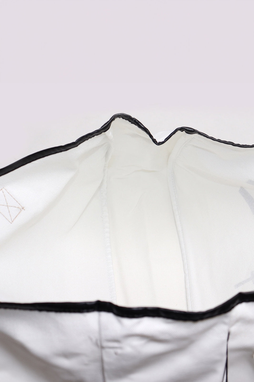 A white sleeveless athletic or casual tank top with black binding trim along the neckline and armholes, displayed flat against a neutral background.