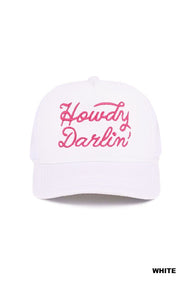 A white baseball cap featuring hot pink embroidered script text reading "Howdy Darlin'" across the front. The cap has a curved bill and classic six-panel construction.