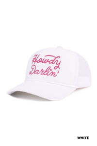 A white baseball cap with pink embroidered script text reading "Howdy Darlin'" across the front. The cap features a curved bill and classic structured design.