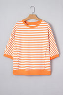 A bright orange and white striped short-sleeve sweatshirt displayed on a wooden hanger against a gray background. The garment features horizontal stripes throughout, ribbed cuffs and hem, and a classic crew neckline.