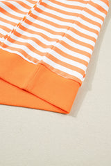 Close-up of an orange and white striped short-sleeve shirt with ribbed orange trim at the cuffs and hem, displayed flat on a neutral background.