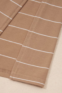 Close-up of a beige ribbed sweater or knit garment featuring white horizontal stripes throughout, displayed flat on a neutral background.