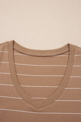 A tan ribbed tank top with white horizontal stripes, featuring a V-neckline and fitted shoulders, displayed flat against a neutral beige background.