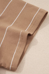 Close-up of a beige striped knit fabric with white vertical stripes and a rolled edge detail, showing the garment's texture and construction seaming.