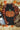 Black sleeveless tank top featuring a glittery orange pumpkin with a green stem, displayed flat lay with a plaid flannel shirt, autumn leaves, small pumpkins, boots, and fall decorations on a wooden background.