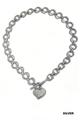 A silver-toned chain necklace with interlocking circular links and a polished heart-shaped pendant hanging from a toggle clasp.