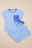 A two-piece children's pajama set in light blue and white stripes featuring a short-sleeved t-shirt with a solid blue chest pocket and matching striped shorts with an elastic drawstring waist.